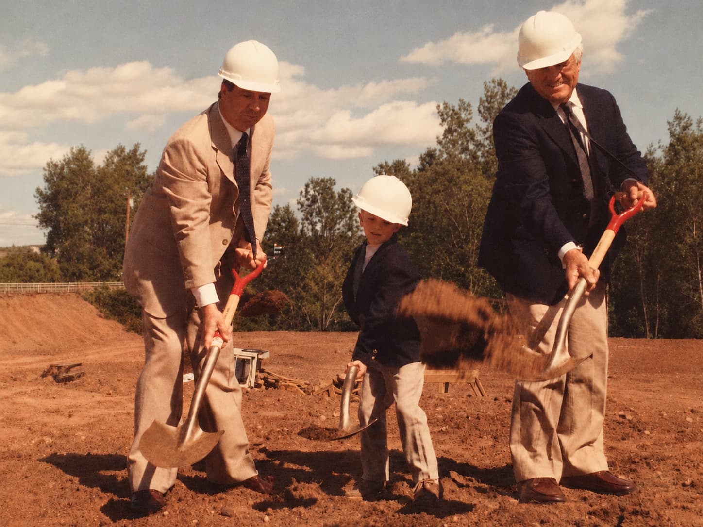 Three generations of the Annulli family — Lon, a young Adam, and Orlando Annulli — at a company groundbreaking